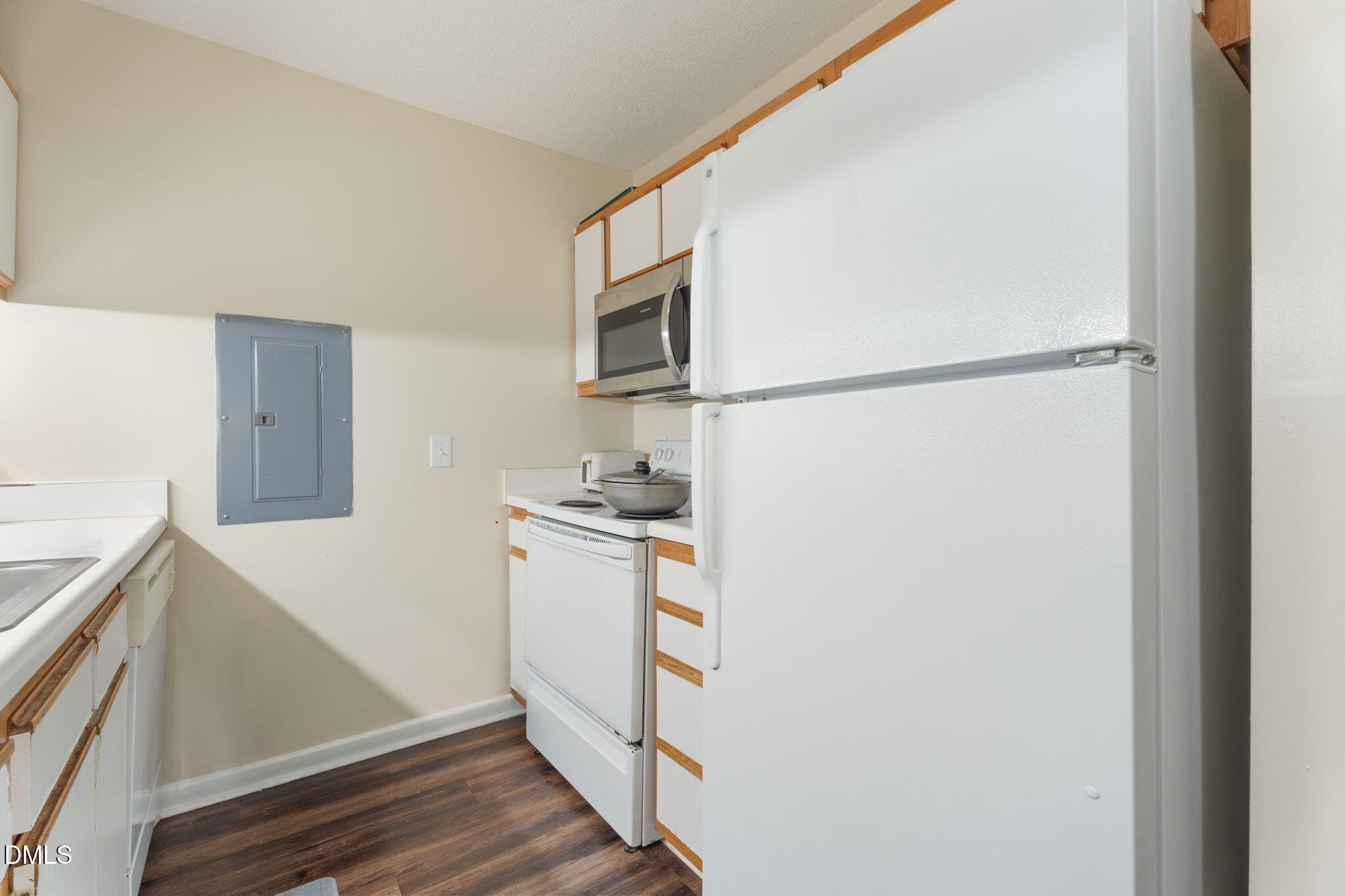 1420 Collegiate Circle Raleigh, NC 27606 - Photo 26 of 30 a kitchen with a refrigerator sink stove and cabinets