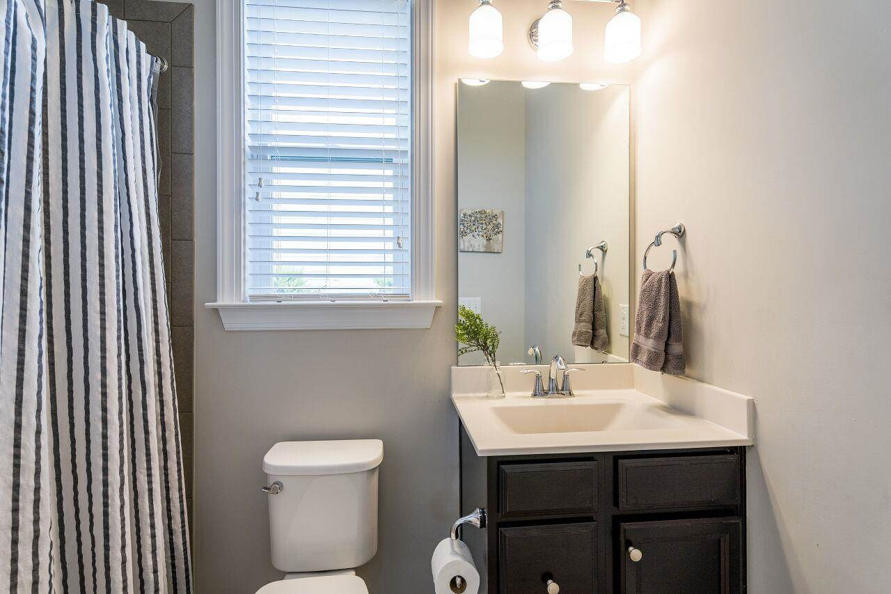 5264 Aleppo Lane Raleigh, NC 27613 - Photo 17 of 30 Downstairs full guest bathroom features tiled shower and floors. Guest Bathroom