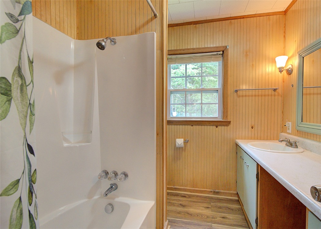 5064 Keowee School Road Seneca, SC 29672 - Photo 29 of 49 This bathroom features paneled walls and a window, creating a light and inviting atmosphere.