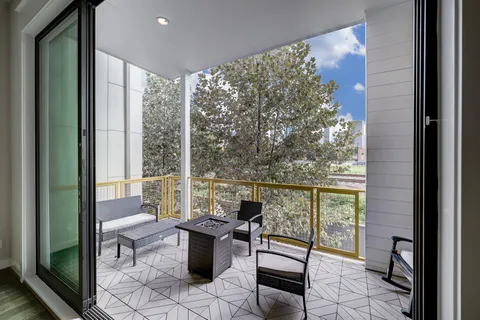 a living room with furniture and large windows