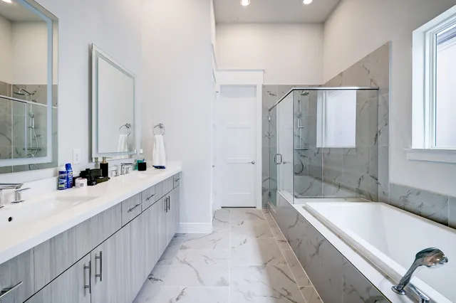 a bathroom with a tub sink and mirror