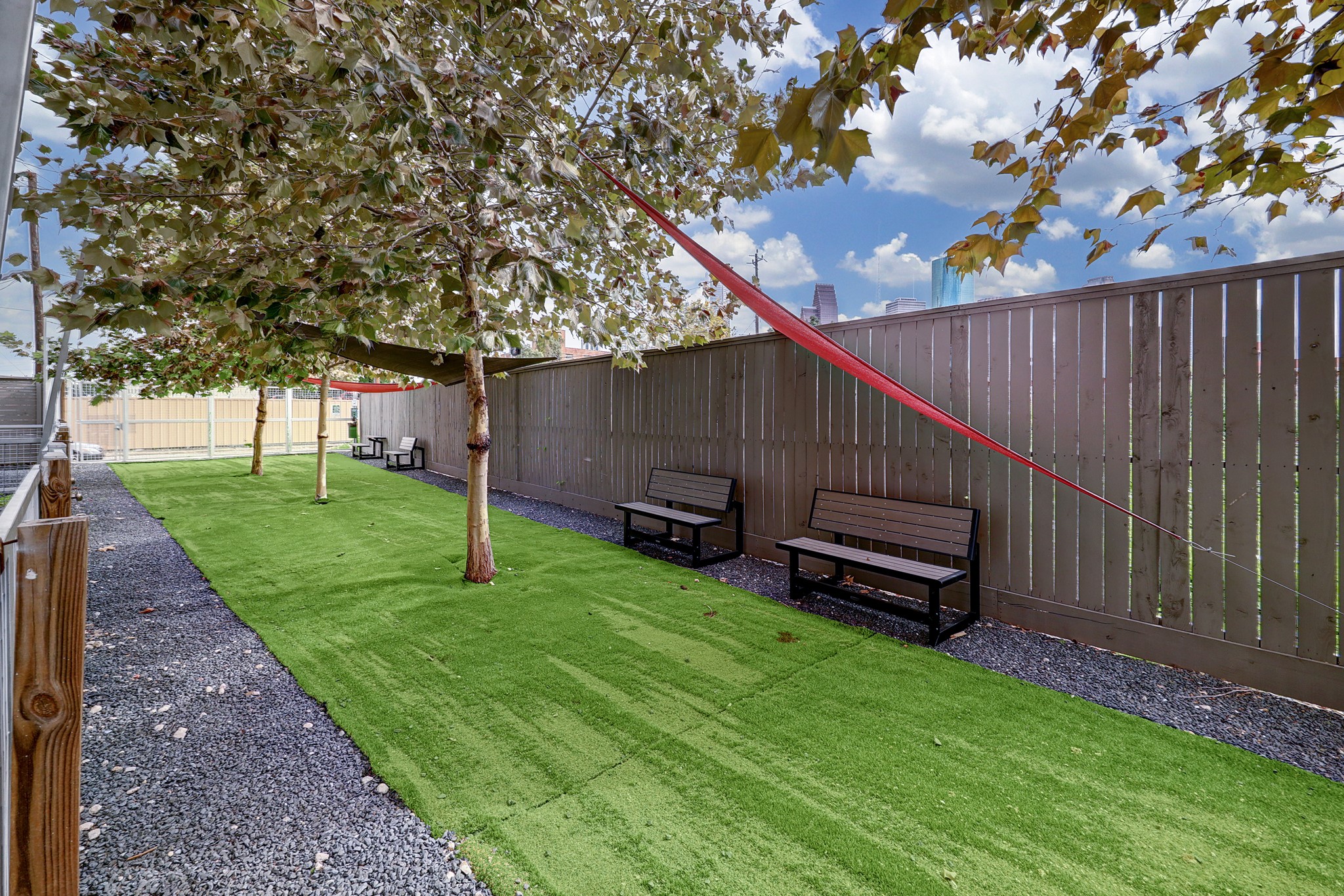 1203 Hickory Street, Unit D Houston, TX 77007 - Photo 22 of 23 a backyard of a house with lots of green space and wooden fence