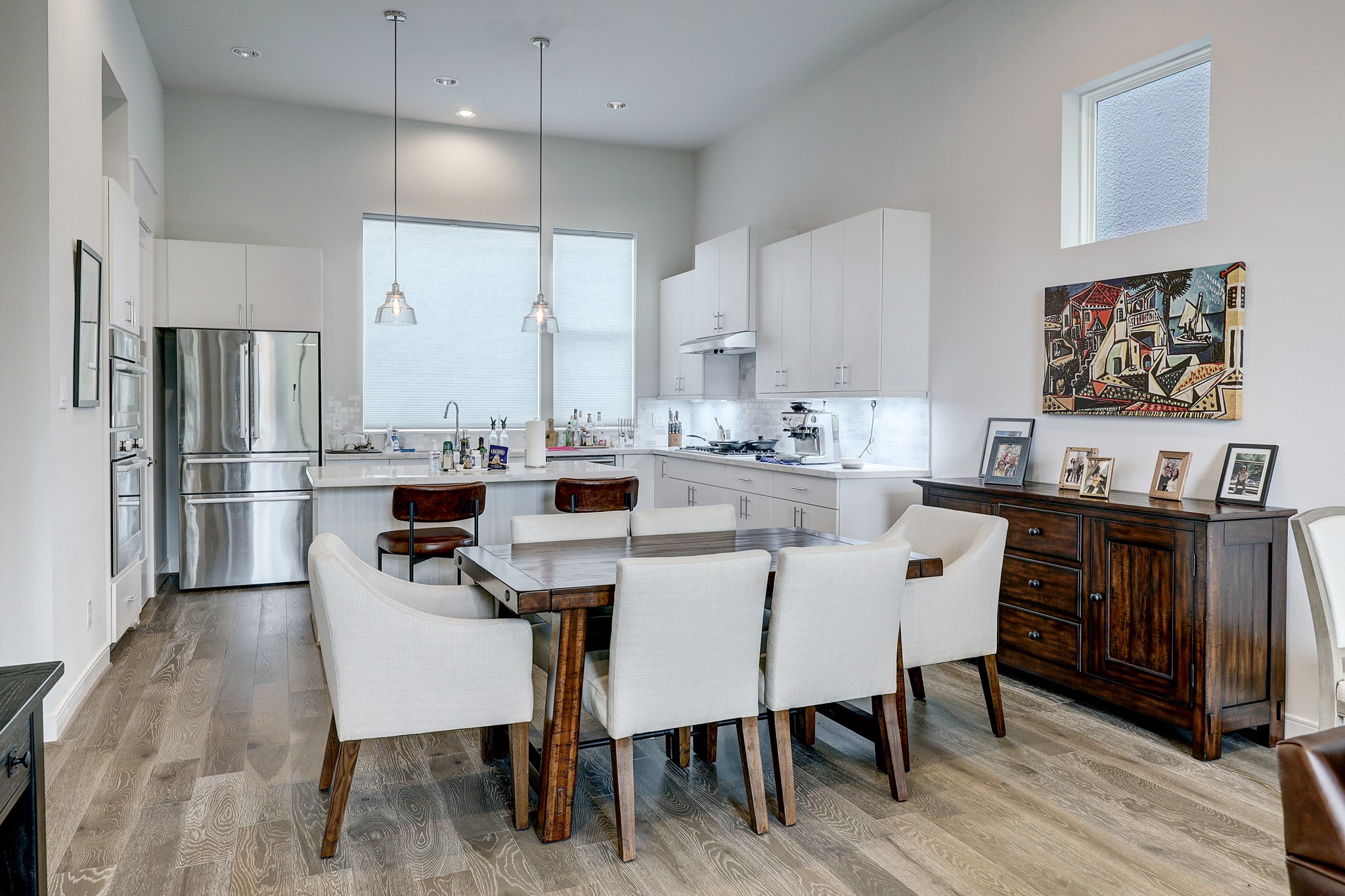 1203 Hickory Street, Unit D Houston, TX 77007 - Photo 7 of 23 a kitchen with stainless steel appliances a dining table chairs refrigerator and sink