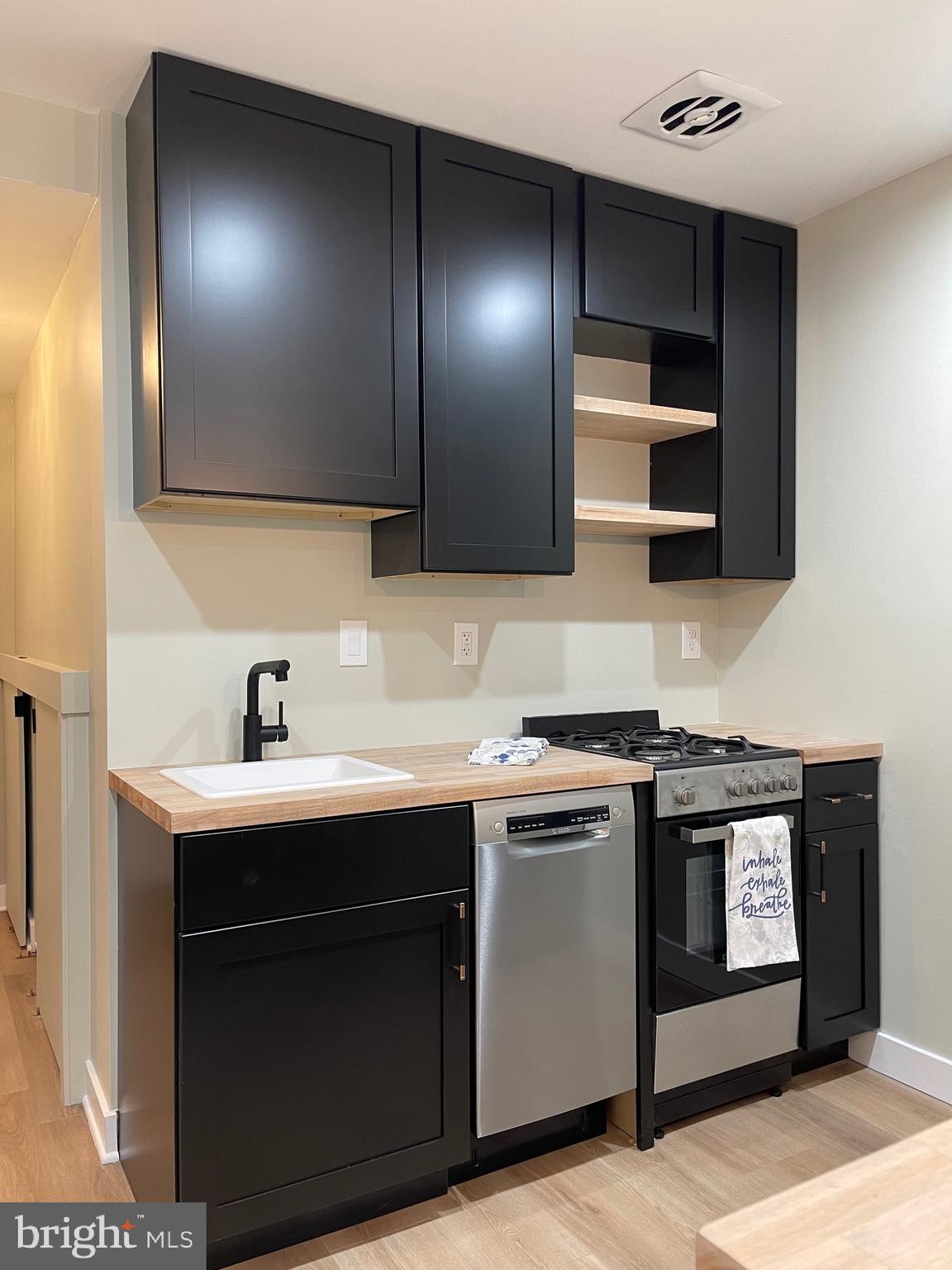 620 3rd Street Southwest Washington, DC 20024 - Photo 5 of 44 a kitchen with stainless steel appliances granite countertop a sink and a stove