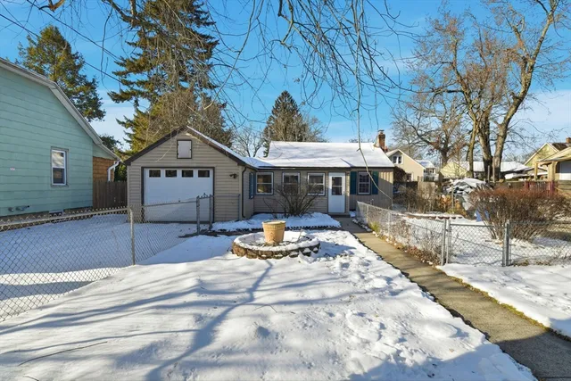 a view of a house with a yard covered with snow in the outdoor space