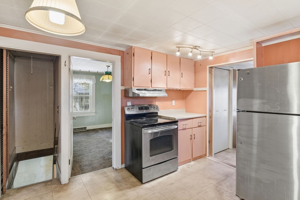 138 Warrenton Street Springfield, MA 01109 - Photo 11 of 33 a kitchen with stainless steel appliances granite countertop a refrigerator a stove and a sink