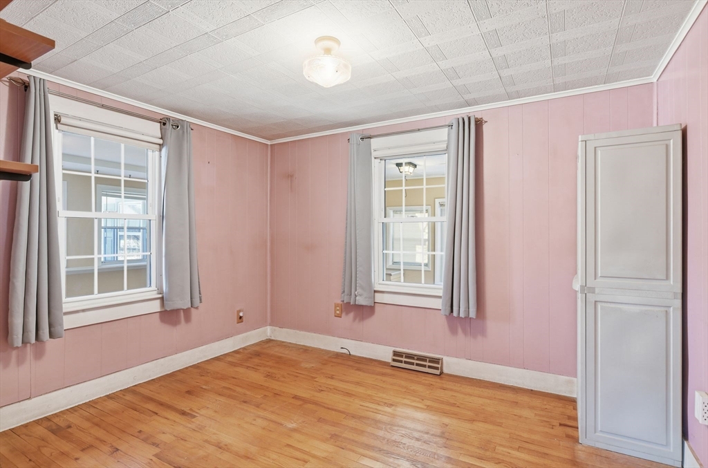 138 Warrenton Street Springfield, MA 01109 - Photo 15 of 33 an empty room with wooden floor and windows
