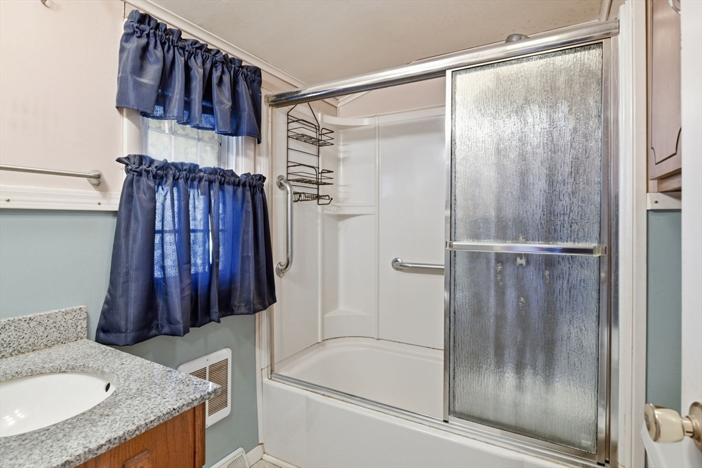 138 Warrenton Street Springfield, MA 01109 - Photo 23 of 33 a bathroom with a granite countertop shower a sink and a toilet
