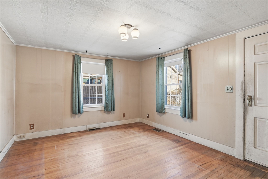 138 Warrenton Street Springfield, MA 01109 - Photo 8 of 33 a view of an empty room with a window and wooden floor