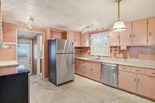a kitchen with refrigerator cabinets and a sink