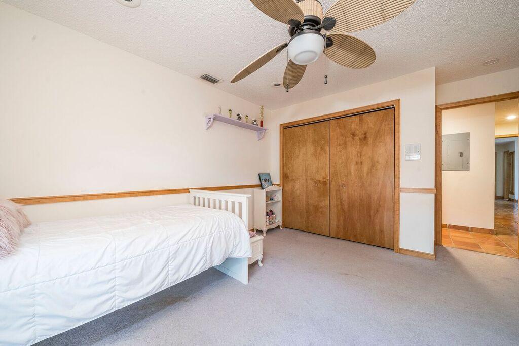 6761 Entrada Place Boca Raton, FL 33433 - Photo 52 of 69 a spacious bedroom with a bed and a chandelier
