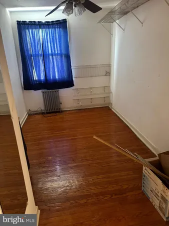 a view of a closet with wooden floor