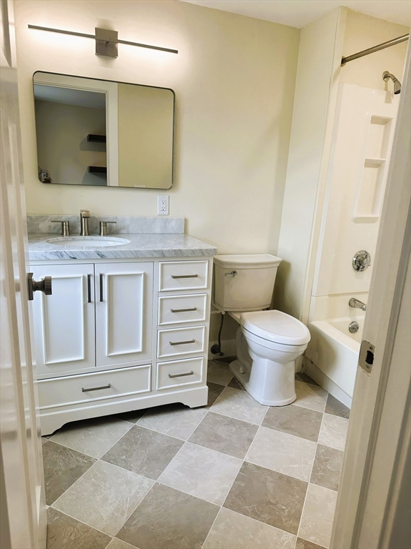 15 Clark Street, Unit 3 Boston, MA 02113 - Photo 6 of 8 a bathroom with a granite countertop toilet sink and mirror