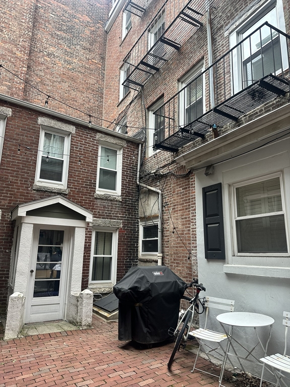 15 Clark Street, Unit 3 Boston, MA 02113 - Photo 7 of 8 a building with table and chairs