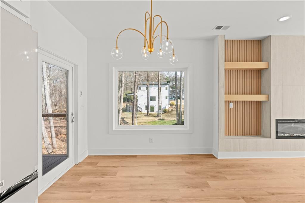 744 Crystal Bay Road Villa Rica, GA 30180 - Photo 15 of 69 a view of an empty room with window and wooden floor