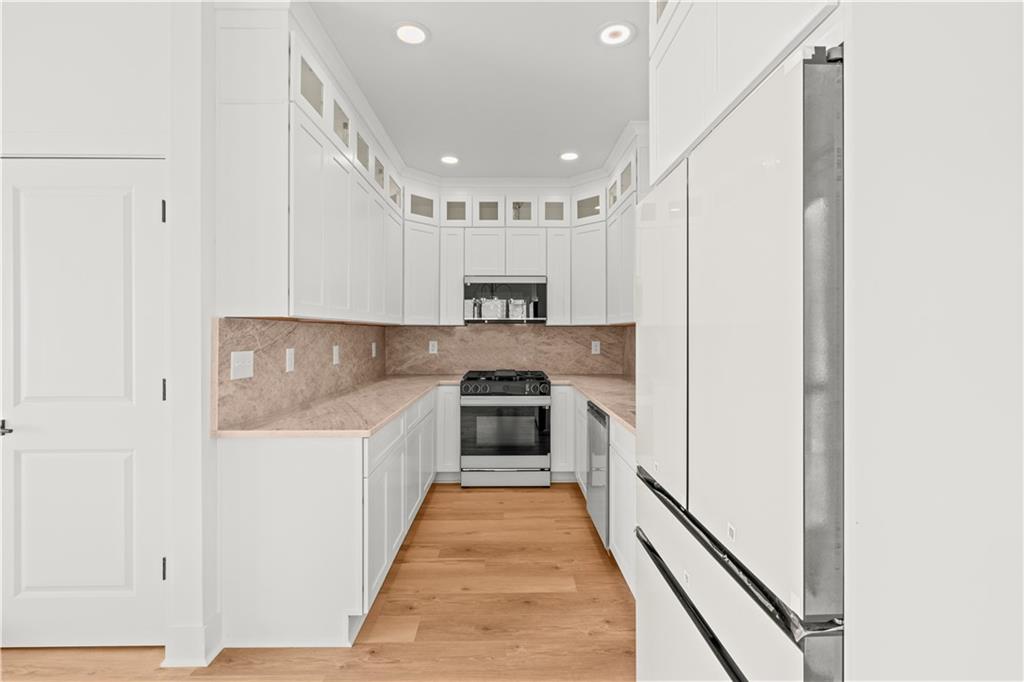 744 Crystal Bay Road Villa Rica, GA 30180 - Photo 17 of 69 a kitchen with a refrigerator and a stove