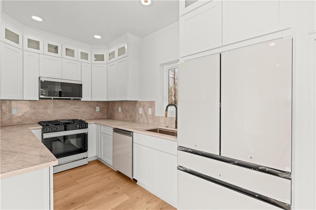 744 Crystal Bay Road Villa Rica, GA 30180 - Photo 18 of 69 a kitchen with stainless steel appliances a refrigerator sink and microwave