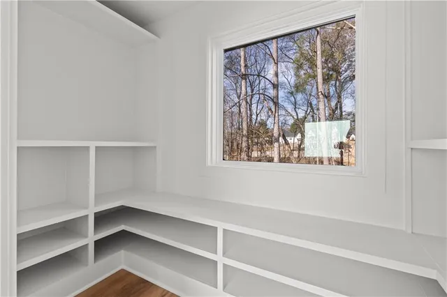 a view of an empty room with wooden floor