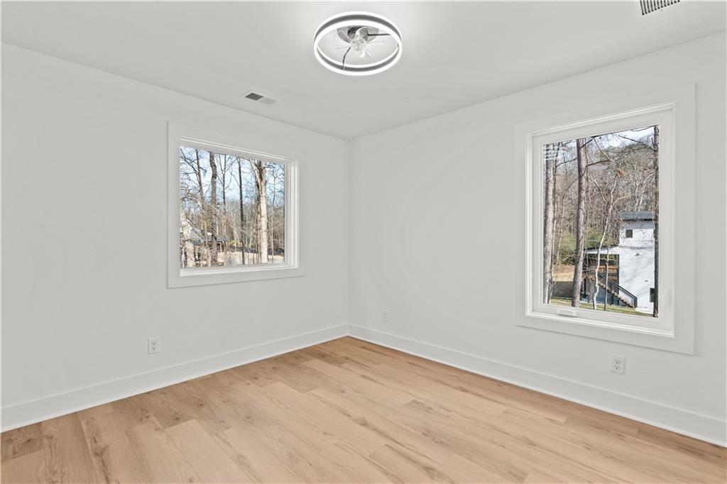744 Crystal Bay Road Villa Rica, GA 30180 - Photo 36 of 69 a view of empty room with window and wooden floor