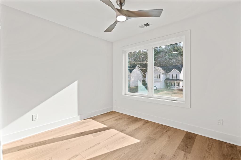 744 Crystal Bay Road Villa Rica, GA 30180 - Photo 37 of 69 a view of an empty room with wooden floor and a window