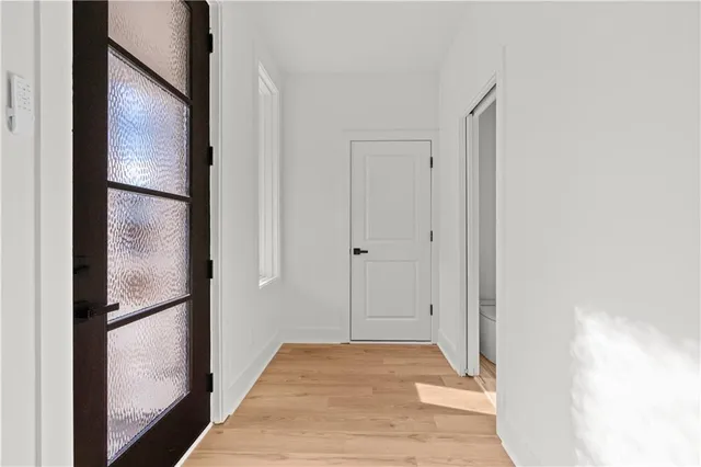 a view of an empty room and wooden floor