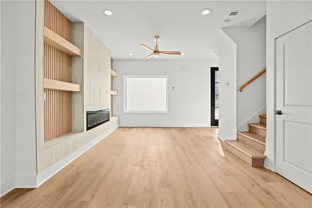 an empty room with wooden floor and white walls