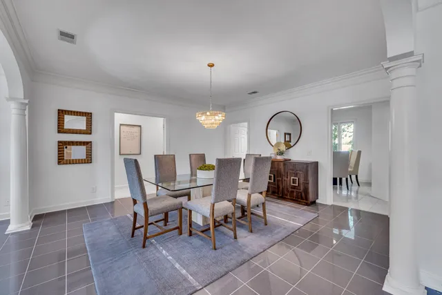 a view of a dining room with furniture and a large window