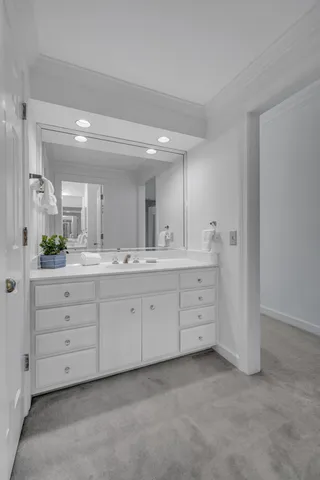 a spacious bathroom with a double vanity sink and a mirror