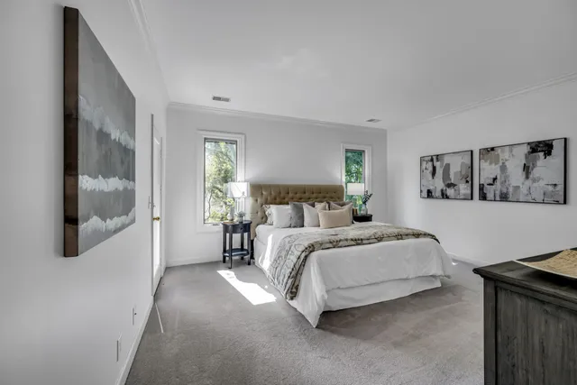 a spacious bedroom with a bed and wall painting