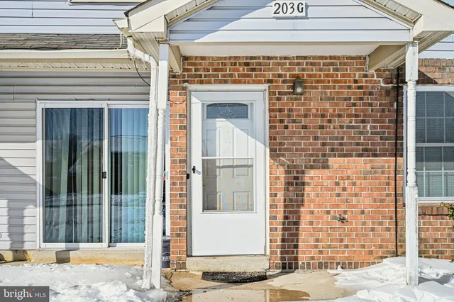 a view of a white house with large windows