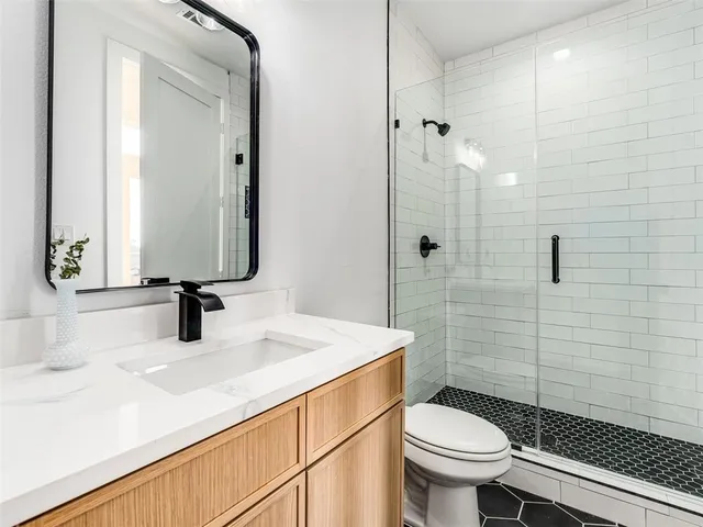 a bathroom with a sink toilet and shower