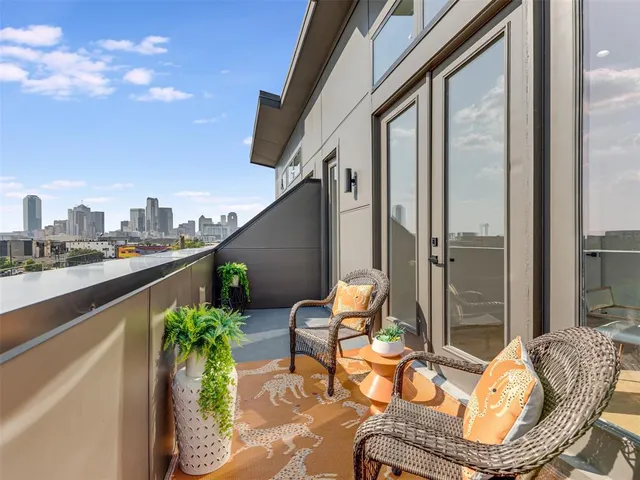a balcony with furniture and a potted plant