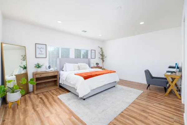 a bedroom with a bed and a table