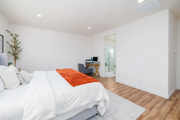a bedroom with a bed and a lamp