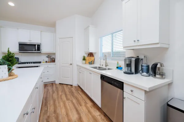 a kitchen with a sink a stove and cabinets
