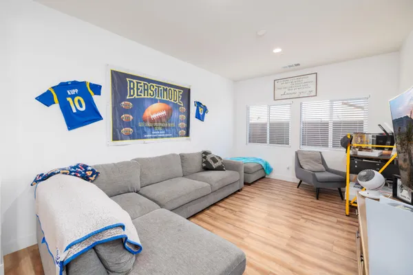 a living room with furniture and a floor to ceiling window