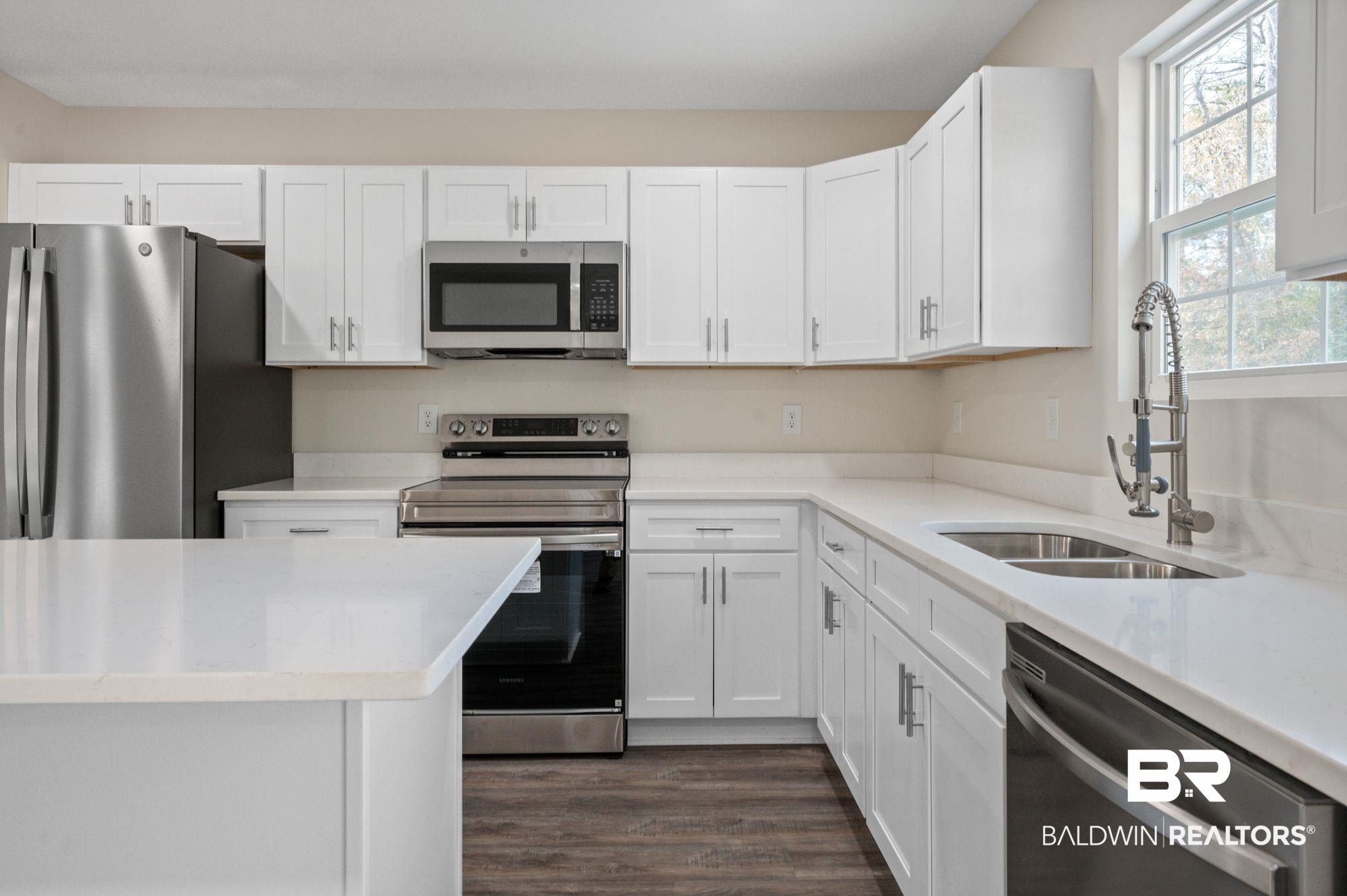 1473 Pollard Road Daphne, AL 36526 - Photo 15 of 32 Kitchen with white cabinetry, stainless steel appliances, dark hardwood / wood-style flooring, and sink