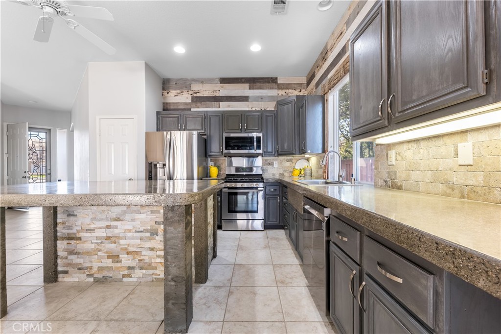 40445 Chantemar Way Temecula, CA 92591 - Photo 11 of 28 a kitchen with stainless steel appliances granite countertop a sink and stove
