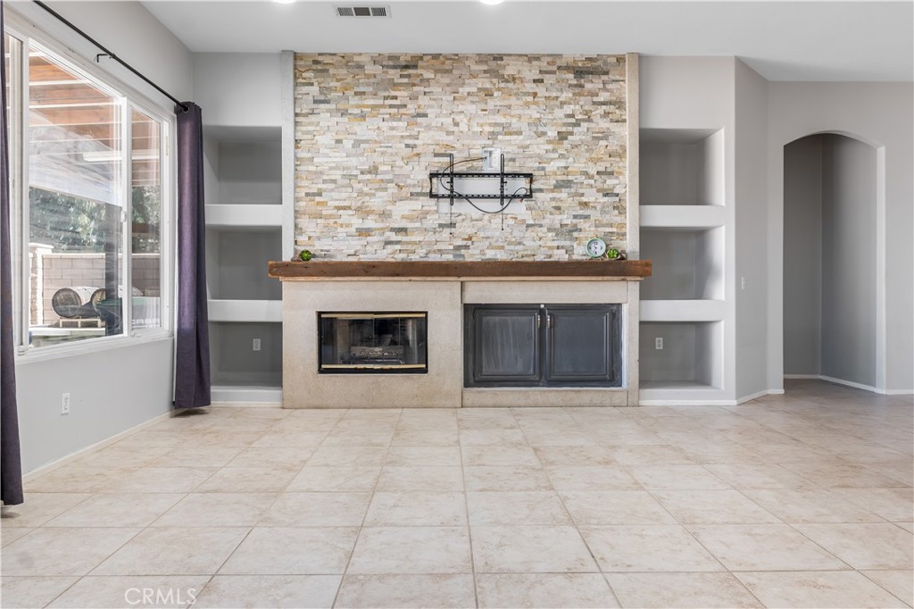 40445 Chantemar Way Temecula, CA 92591 - Photo 12 of 28 a view of an empty room with a fireplace and a window