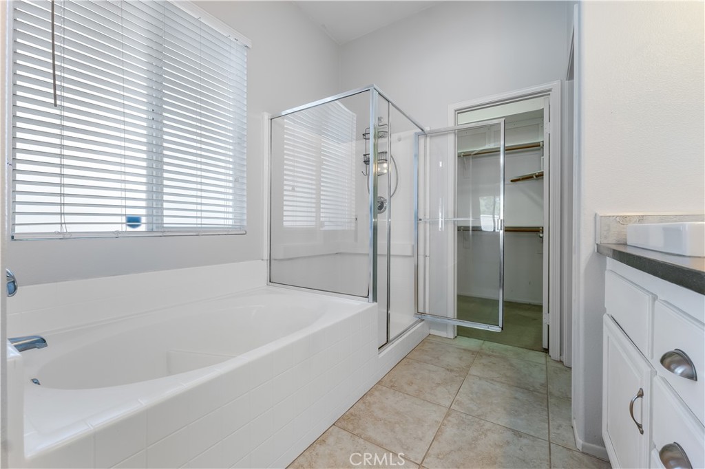 40445 Chantemar Way Temecula, CA 92591 - Photo 16 of 28 a bathroom with a bathtub and a shower