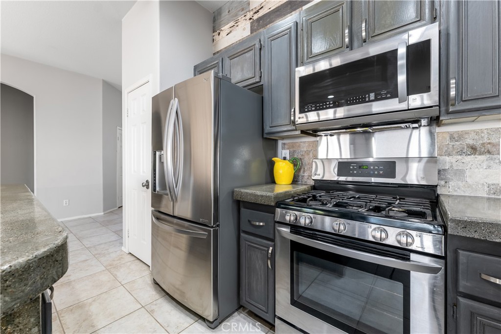40445 Chantemar Way Temecula, CA 92591 - Photo 10 of 28 a kitchen with stainless steel appliances and granite countertop a stove top oven