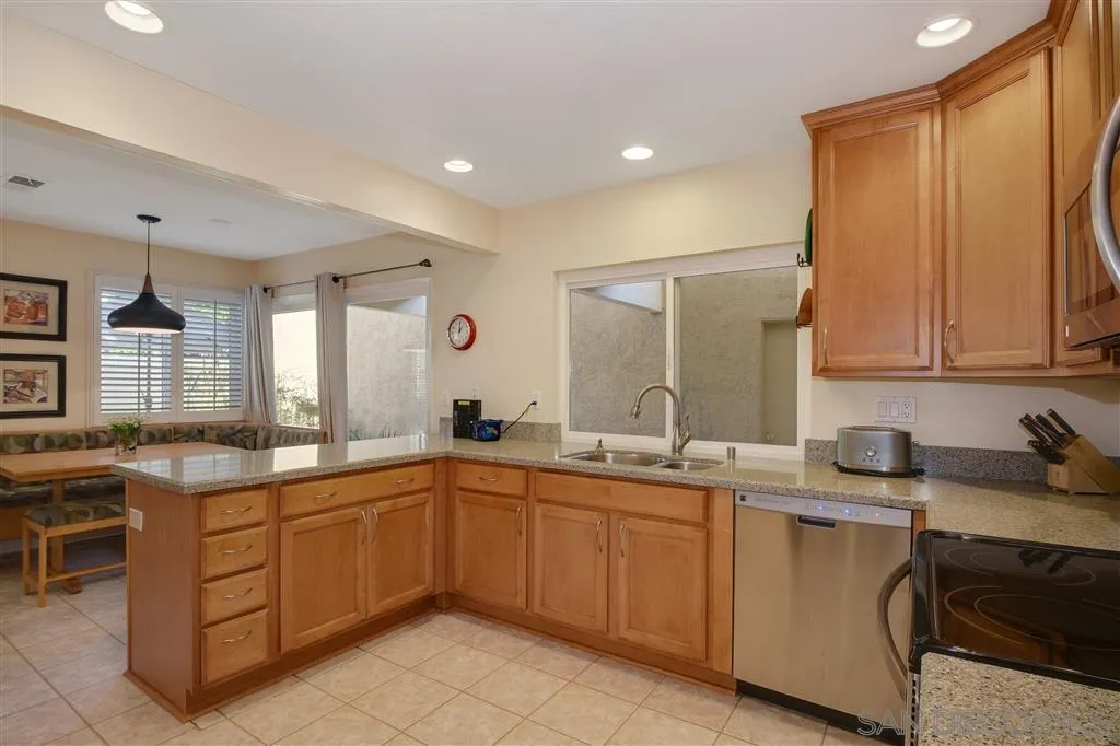 210 Countryhaven Road Encinitas, CA 92024 - Photo 11 of 25 a kitchen with a sink and cabinets