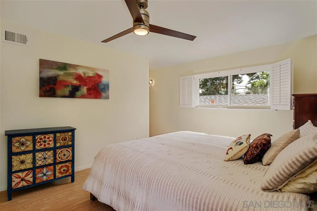 210 Countryhaven Road Encinitas, CA 92024 - Photo 16 of 25 a bedroom with a bed a painting on the wall and a window