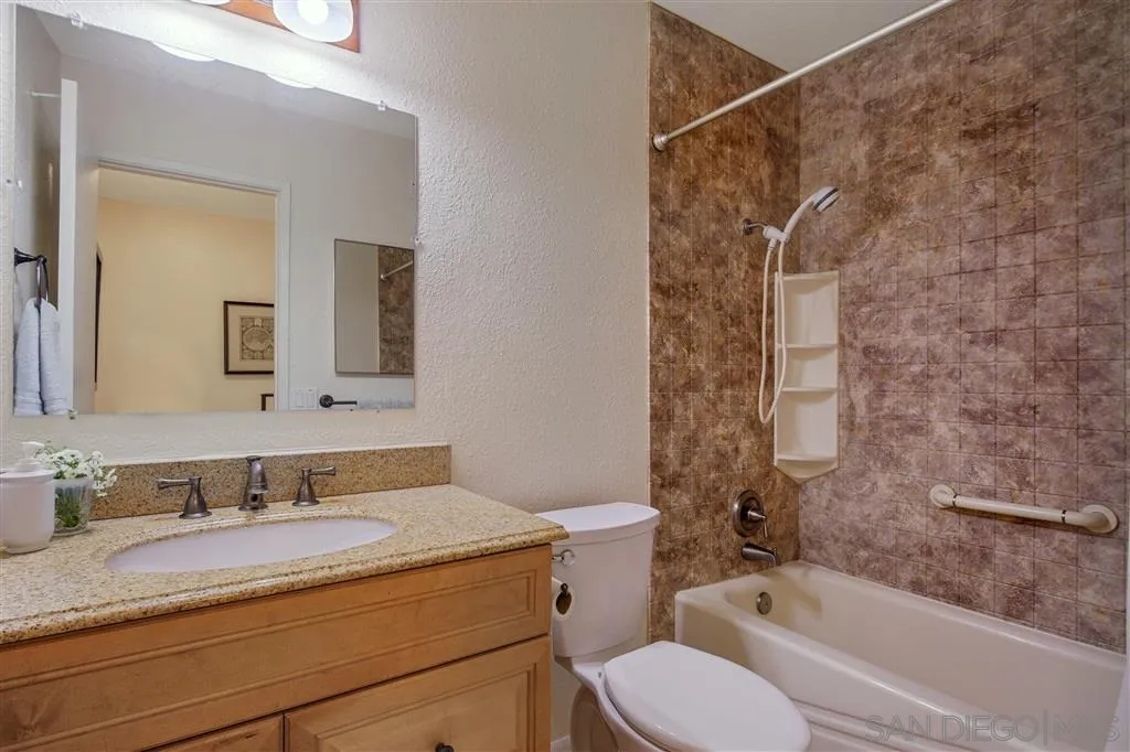 210 Countryhaven Road Encinitas, CA 92024 - Photo 21 of 25 a bathroom with a granite countertop sink toilet and shower