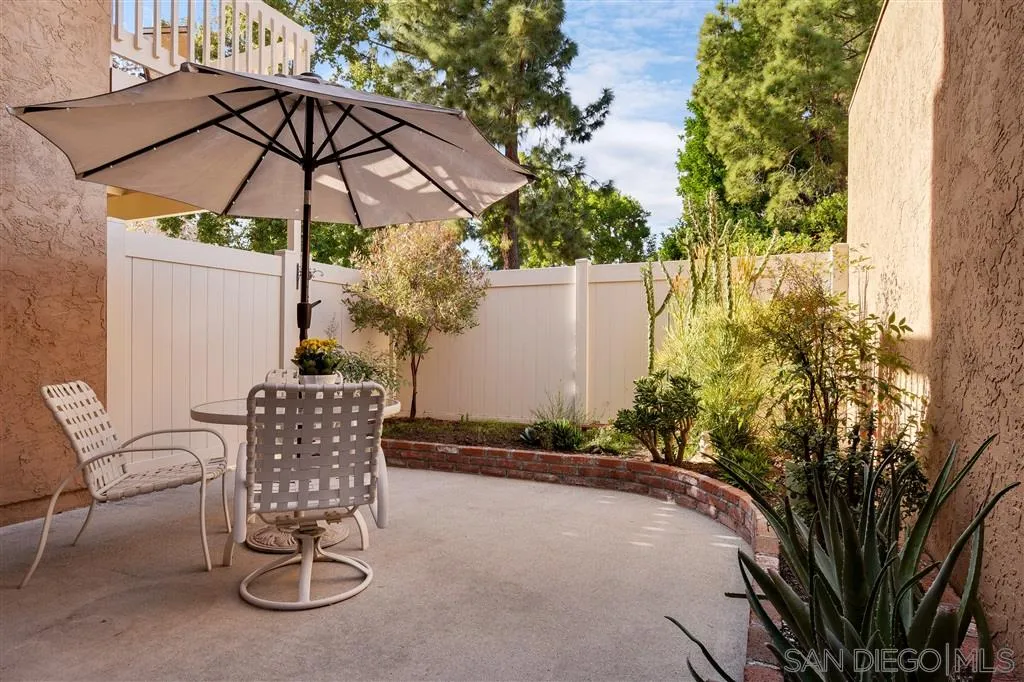210 Countryhaven Road Encinitas, CA 92024 - Photo 22 of 25 a patio with a table and chairs under an umbrella