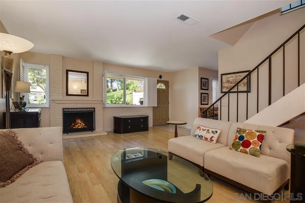 210 Countryhaven Road Encinitas, CA 92024 - Photo 5 of 25 a living room with furniture a fireplace and a flat screen tv