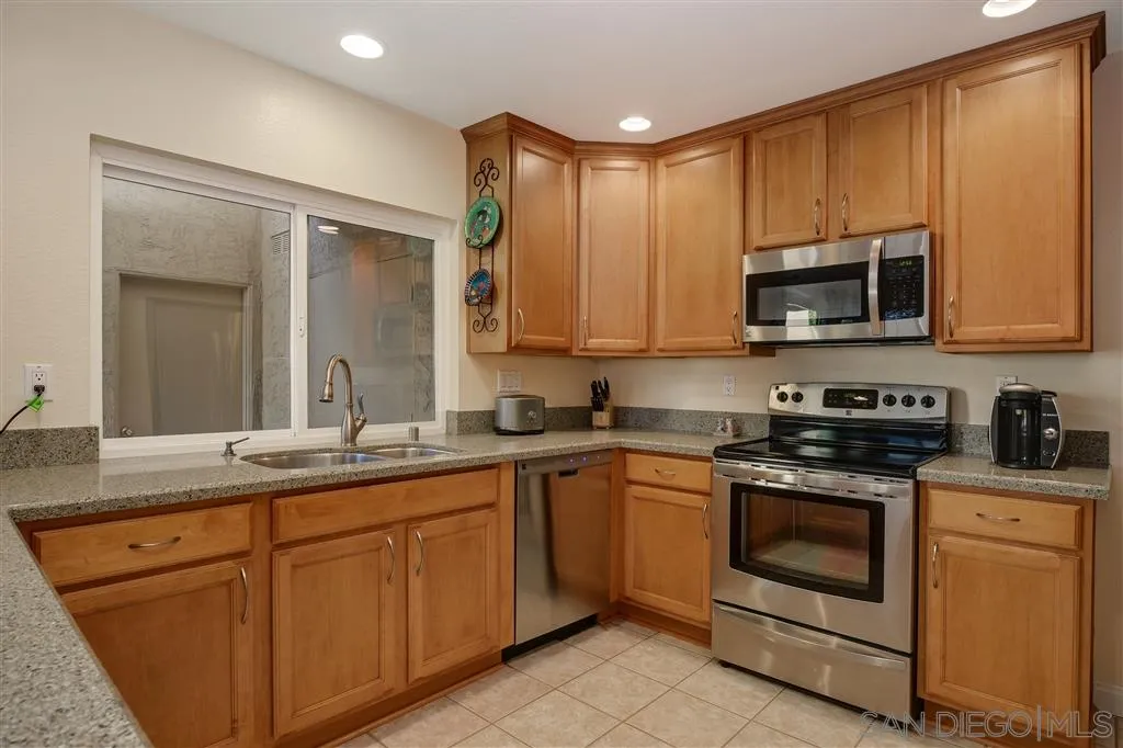 210 Countryhaven Road Encinitas, CA 92024 - Photo 9 of 25 a kitchen with a sink stove and microwave