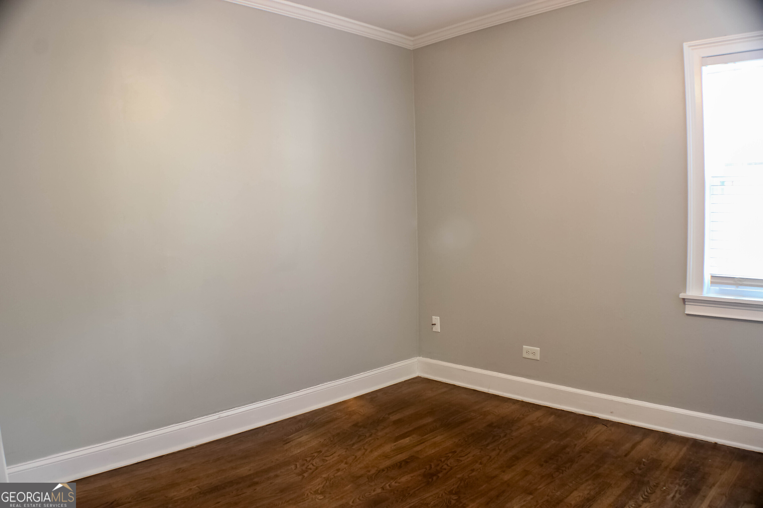 311 Roswell Avenue Southeast Rome, GA 30161 - Photo 13 of 21 a view of an empty room with wooden floor and a window