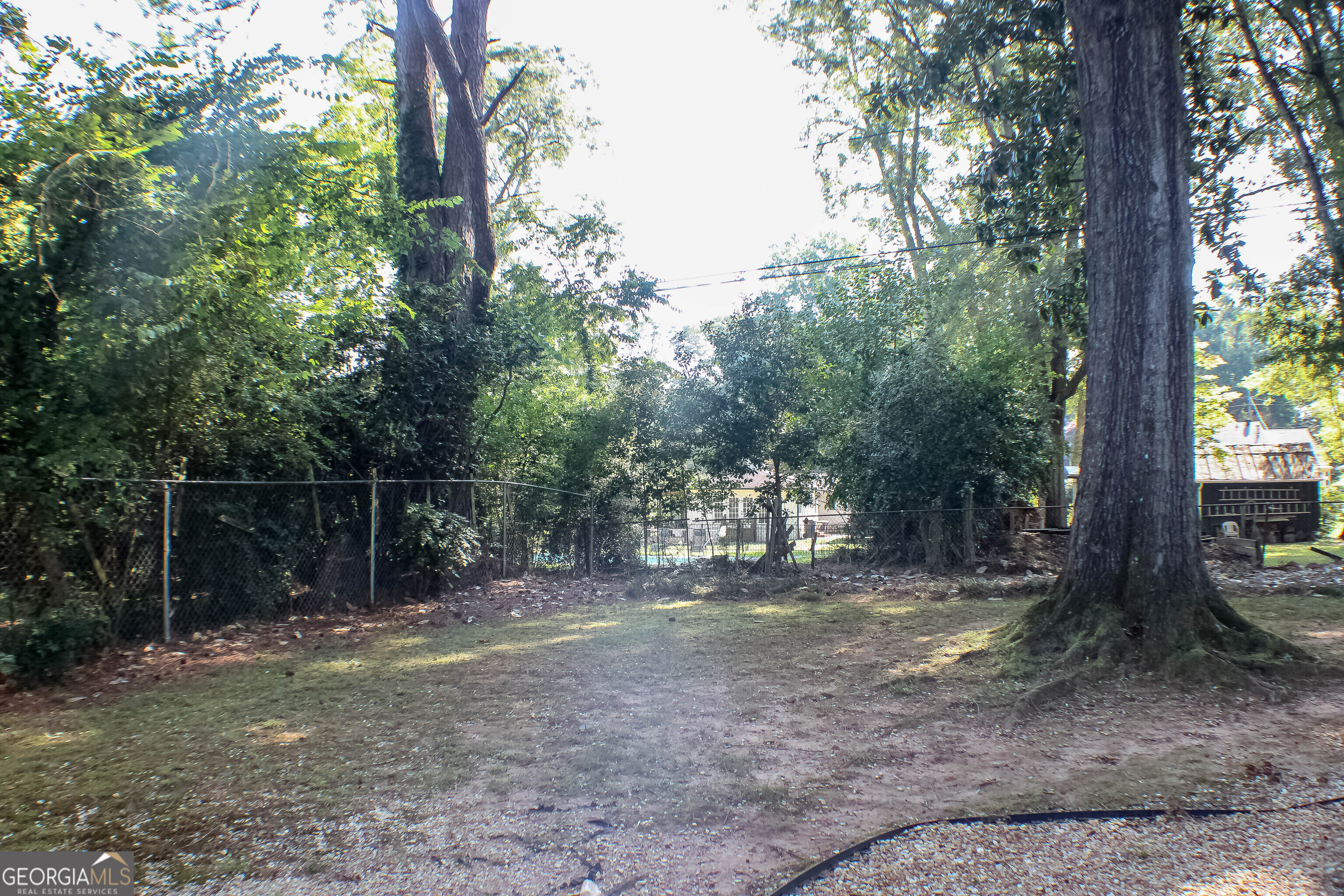 311 Roswell Avenue Southeast Rome, GA 30161 - Photo 21 of 21 a backyard of a house with lots of trees