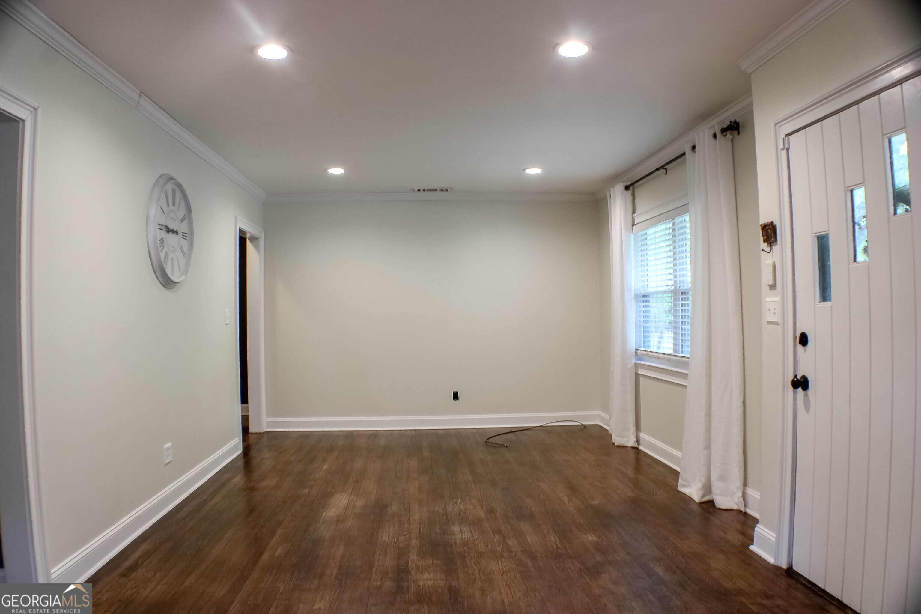 311 Roswell Avenue Southeast Rome, GA 30161 - Photo 4 of 21 an empty room with wooden floor and window